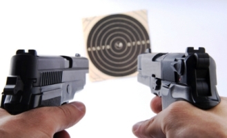 Picture of two guns black in color, handguns shooting at a target. Which is a bb gun and which is an Airsoft gun?