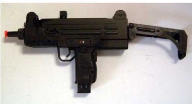 Picture of an Airsoft Uzi gun all black mini, with an orange tip